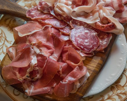 Typical various italian salami, servided on plate at restaurant.