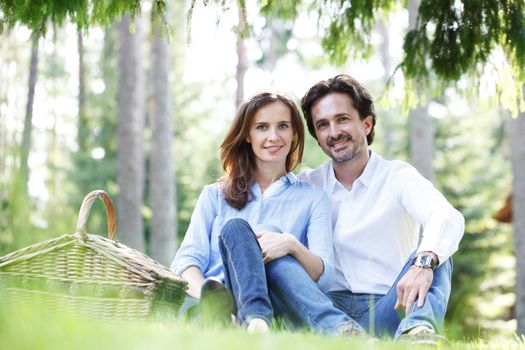 Young beautiful couple on picnic in summer park