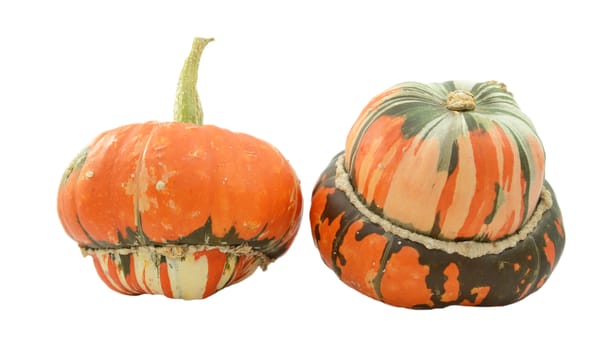Two Turks turban squash, one with stem on top, one showing boldly striped gourd, isolated on a white background