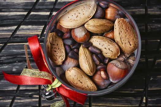 Glass Christmas jar with hazelnuts,almonds and nuts