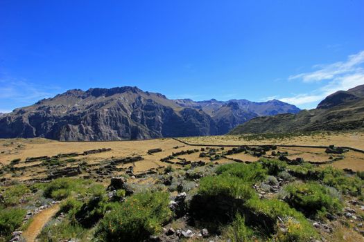 The pre-inca ruins of Maukallacta on the mountain over Puica a peruvian mountain village over the cliffs of the beautiful Cotahuasi Canyon