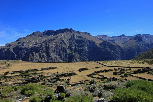 The pre-inca ruins of Maukallacta on the mountain over Puica a peruvian mountain village over the cliffs of the beautiful Cotahuasi Canyon