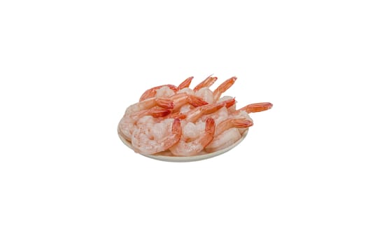 Red peeled prawns lie on a saucer isolated on white background
