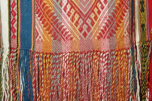 Details shot of wool fabric with colorful pattern, inca indian pattern.