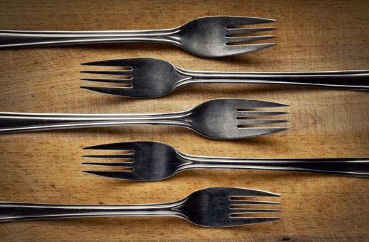 background stainless steel fork on cutting board