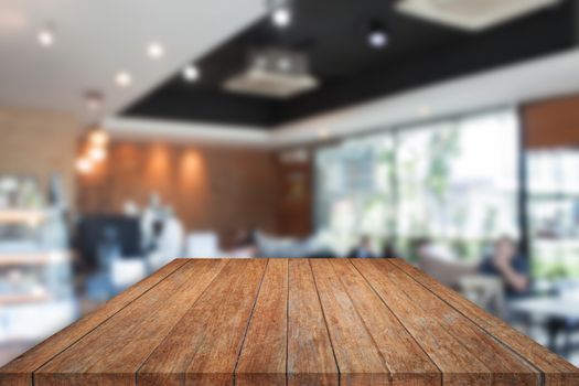 Perspective top brown wooden with blurred cafe interior for background. product display template