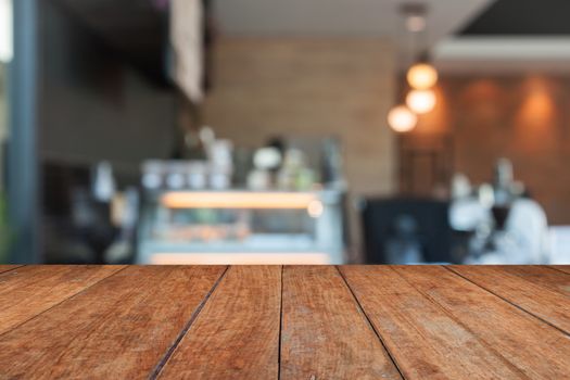 Perspective brown wood with blurred coffee shop, stock photo