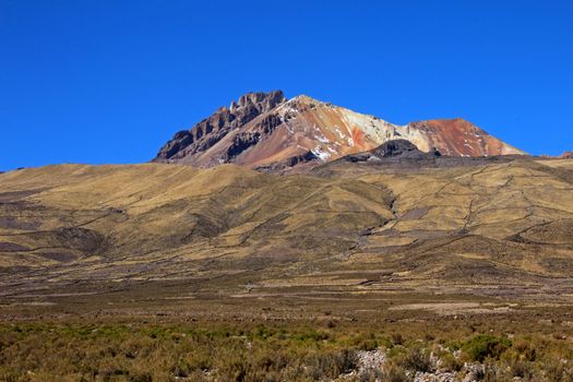 Very colorful dormant volcano Tunupa, the Salar de Uyuni, Bolivia