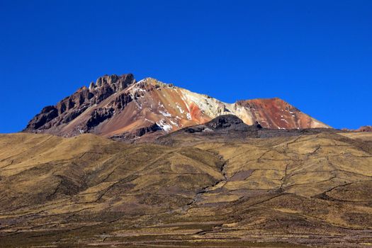 Very colorful dormant volcano Tunupa, the Salar de Uyuni, Bolivia