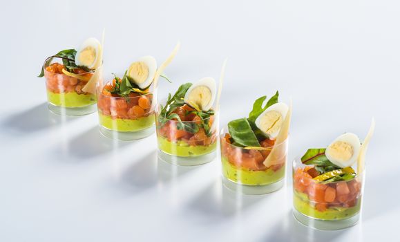Salmon snack wiht and cheese in glass on light background