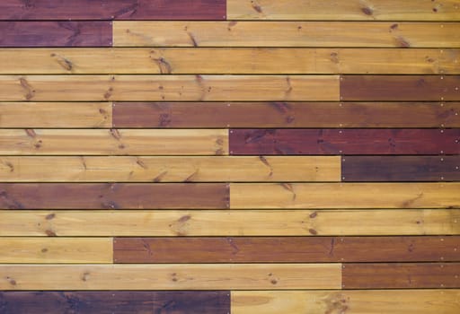 Wooden background of gorizontal brown and yellow pallets