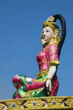 Image of statue of a beautiful woman on sky background. The Sculpture of holy mother earth.