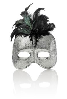 Silver color plastic mask with sequins and feathers isolated on white with reflection.
