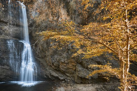 Waterfall Fermona, autumn season in the forest with hot colors of trees