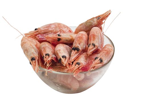 Red peeled prawns lie on a saucer isolated on white background