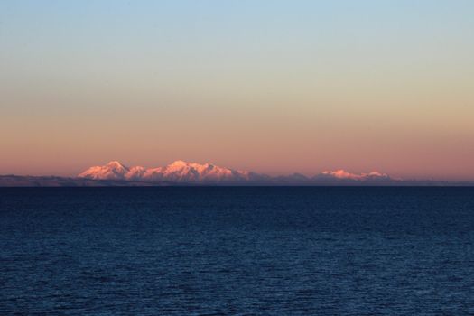 Cordillera real mountain range at sunset behind Titicaca lake, view from the peruvian side.