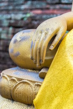 Hand of Buddha with old brick wall background