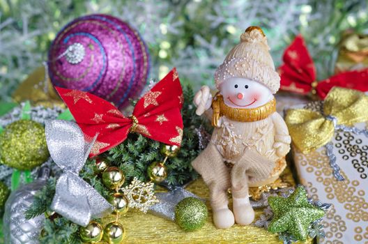 Christmas composition. Cheerful Snowman and Christmas tree decorations.Selective focus.