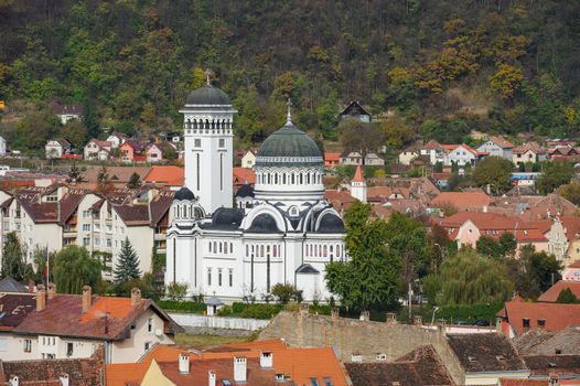 View of the cityscape and Orthodox Christian church in Sighisoara town, Romania