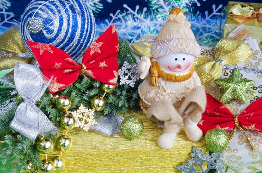 Colorful Christmas arrangement. Cheerful Snowman on gift and Christmas decorations.