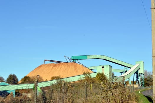 A sawdust hill with a transfer belt