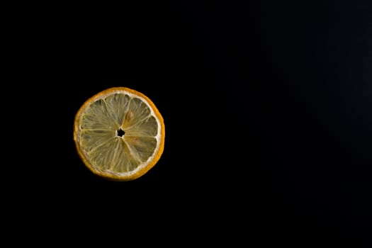 A lemon slice in a black background