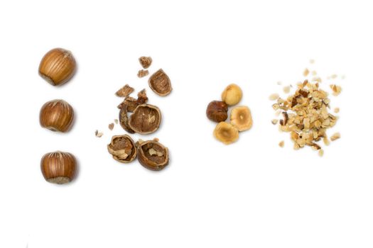 So many hazelnuts in various form on a white background