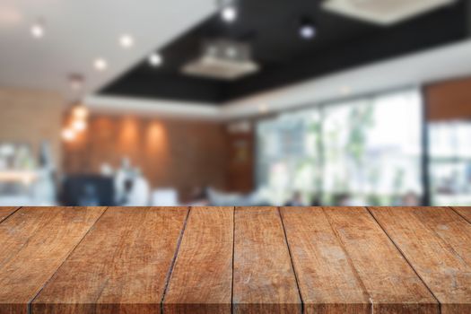 Top of perspective brown wooden with blurred cafe interior for background. product display template