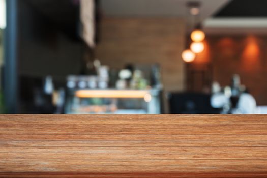 Top of wooden table with blurred coffee shop. product display template