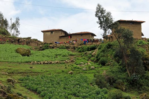 Traditional farmer house in the peruvian mountains with their laundry hanging outside.