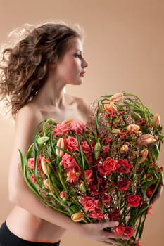 Young beautiful woman with a big bouquet of flowers