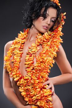Young beautiful nude woman with boa made of rose petals
