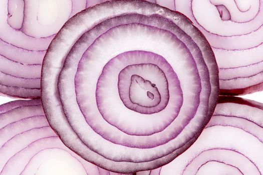 Background of red onion slices, close up