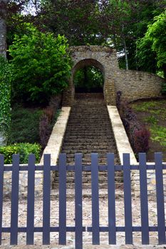 Entrance of a military cemetery to the nature with a stone staircase which rises.