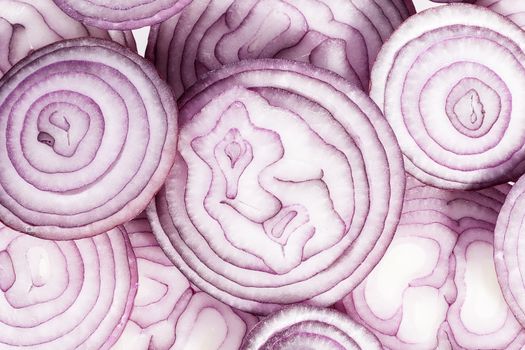 Background of red onion slices, close up.