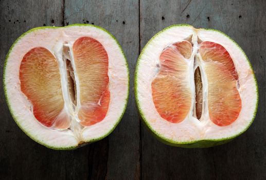 Grapefruit on wood background, tropical fruit, Vietnamese agriculture product, rich vitamin A, healthy eating, reduce cholesterol, prevent kidney stones, oxidation, anti cancer, make lose weight