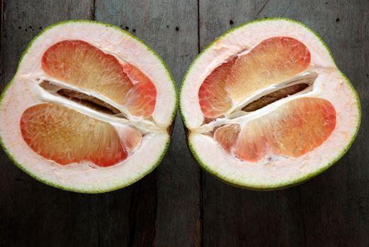 Grapefruit on wood background, tropical fruit, Vietnamese agriculture product, rich vitamin A, healthy eating, reduce cholesterol, prevent kidney stones, oxidation, anti cancer, make lose weight