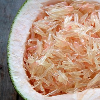 Grapefruit on wood background, tropical fruit, Vietnamese agriculture product, rich vitamin A, healthy eating, reduce cholesterol, prevent kidney stones, oxidation, anti cancer, make lose weight