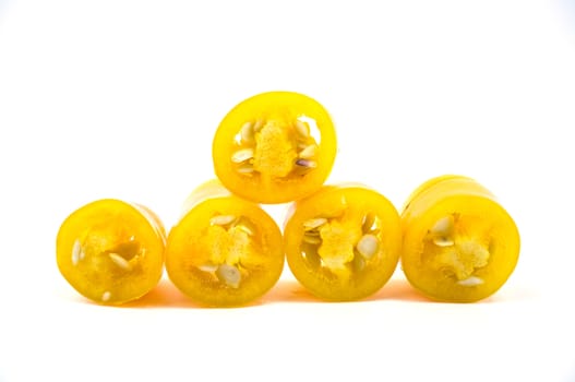 Yellow chilli pepper slices isolated on white background.