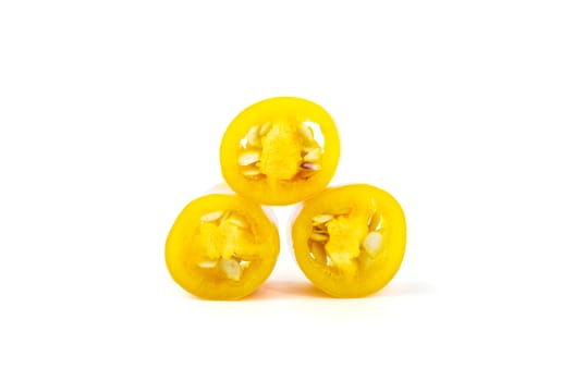 Yellow chilli pepper slices isolated on white background.