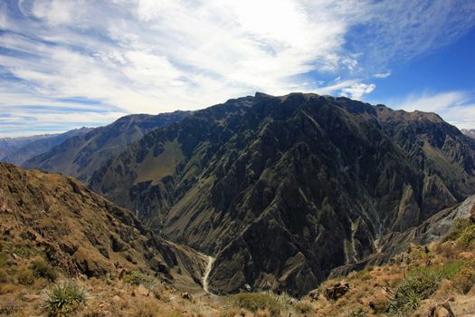 The deep Colca canyon and colca river bend, from panoramic view near cruz del condor. Fisheye perspective. The Colca canyon, one of the deepest canyons in the world, near the city of Arequipa in Peru.