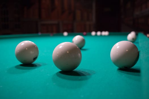 Close-up of Russian billiards: balls on green game table cloth