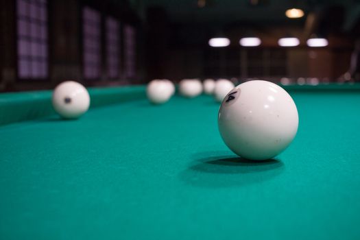 Close-up of Russian billiard, balls on green game table cloth