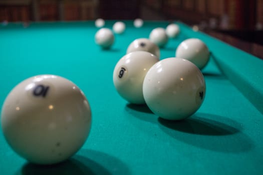 Close-up of Russian billiards game: ball, on green table cloth