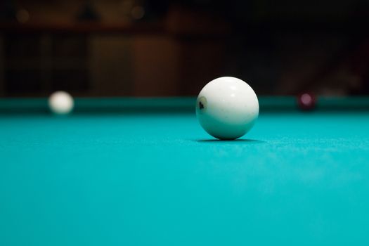 Russian billiards in process, balls on green table