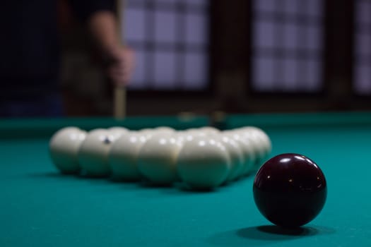 Russian billiards,  black and white balls on green table