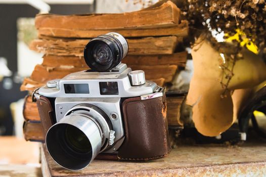 Old camera, stack old books background