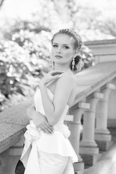 Bride in white dress posing on the photo for a walk
