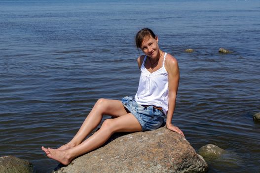 smiling young woman posing on the seaside