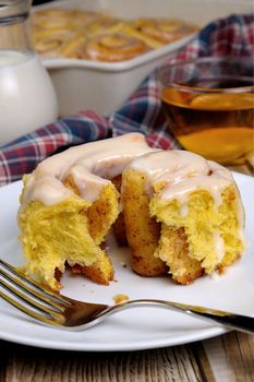 Broken bun of pumpkin with cinnamon in the form of snails closeup
